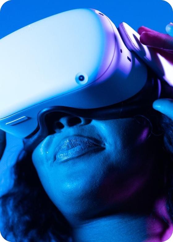 A person wearing a VR headset in blue light
