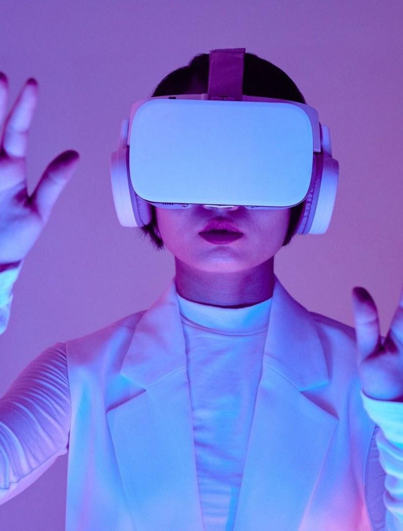 A person wearing a VR headset in purple light